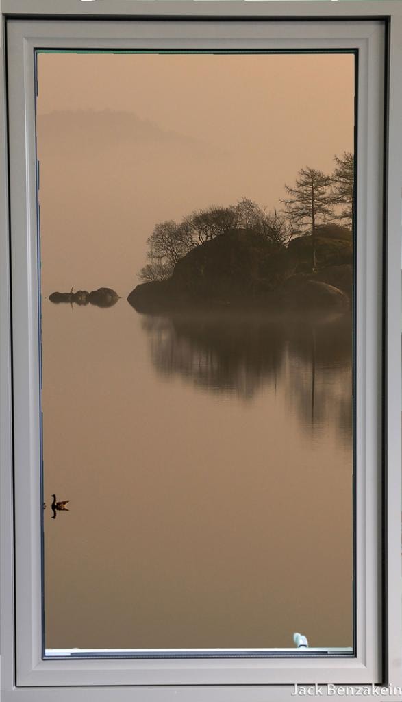 Single casement window misty lake view